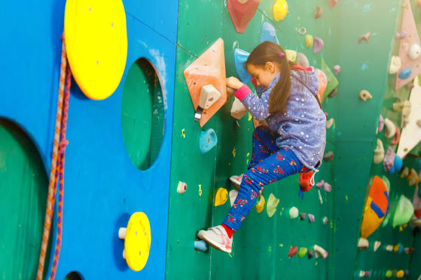 istock Little Girl Climbing Rock Wall 1127612038