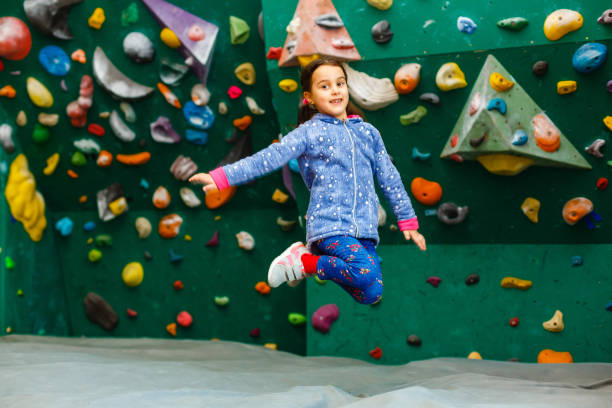 istock Little Girl Climbing Rock Wall 1127612069