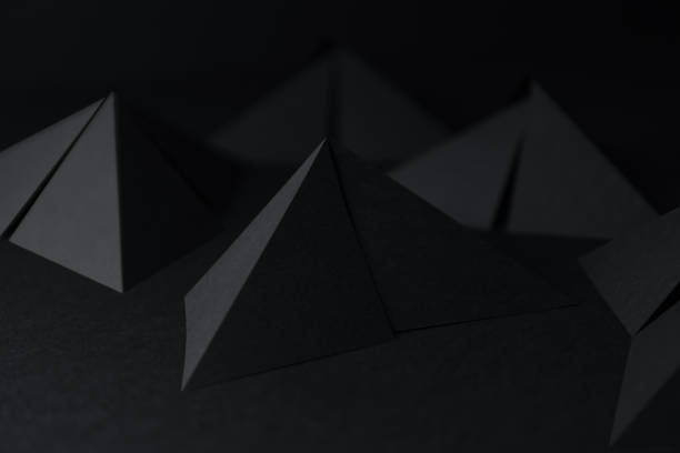 istock Pyramidal shapes of black paper, abstract background 1127612109