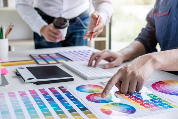 istock Two colleagues creative graphic designer working on color selection and drawing on graphics tablet at workplace 1127612455