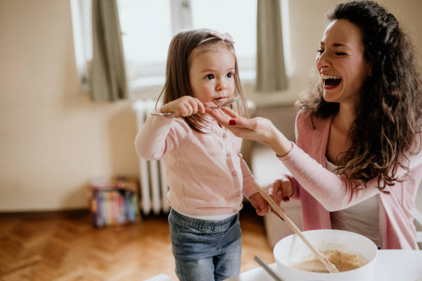 istock Happy mother and daughter in kitchen 1127613425