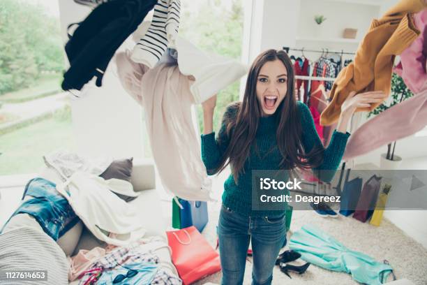 Photo libre de droit de Portrait De Gentil Mignon Séduisante Charmante Assez Joyeux Joyeux Fille Positive Étudiant Jeter Beaucoup Différentes Nouvelles Choses Jour Rêve Rêverie Dans La Lumineuse Salle Intérieur Blanc banque d'images et plus d'images libres de droit de Armoire à vêtements