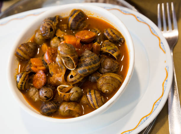 istock Home style snails stewed with chorizo 1127614776