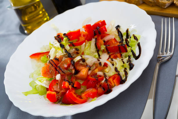 istock Summer vegetable salad - red bell peppers, lettuce and onions 1127614780