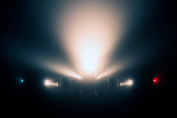 Airplane approaching through morning fog