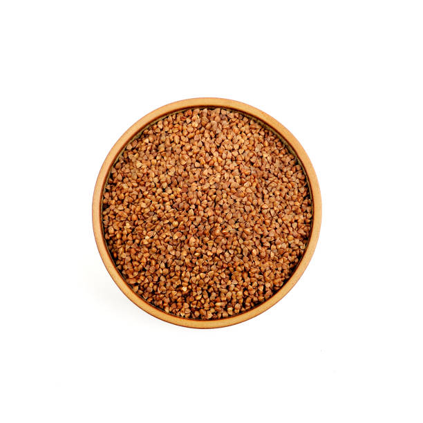 istock Buckwheat in a ceramic bowl isolated on white background. 1127617579