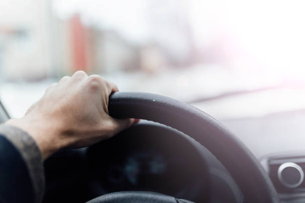 istock driving a driver on a sunny day. bright sunset from the window. 1127618341