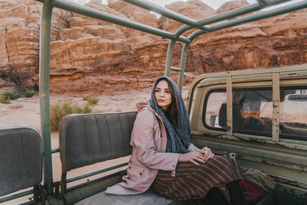 istock Woman riding in SUV through Wadi Rum desert 1127618873
