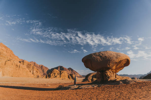 Young Caucasian woman  walking in Wadi Rum desert at sunset