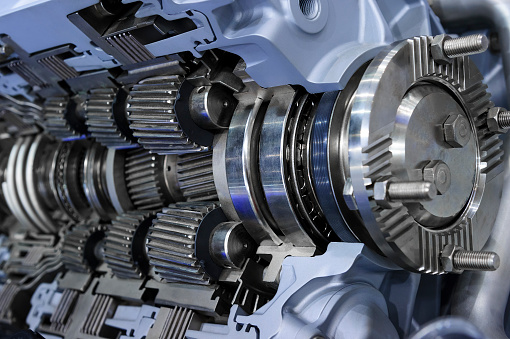 Drive gear and bearings, cross section of bulldozer sprocket internal mechanism, large construction machine with bolts and yellow paint coating, heavy industry, detail