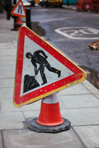 istock road signs of workman digging 1127621154