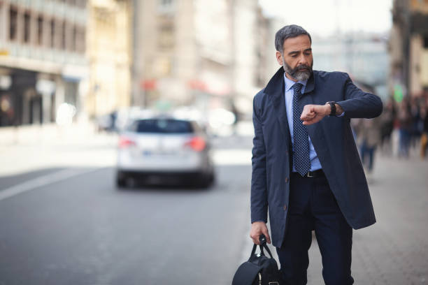 istock Senior businessman in the city using phone on the move 1127622870