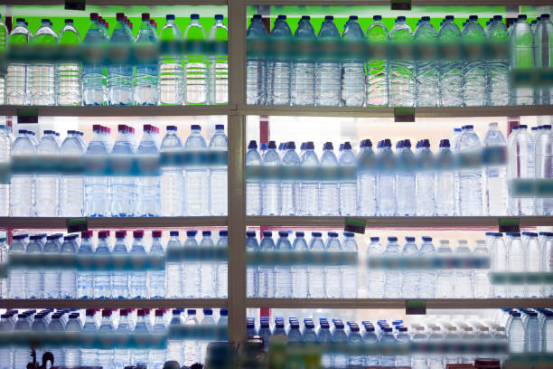 Water bottles in a shop window backlit, full frame view of a  retail display.