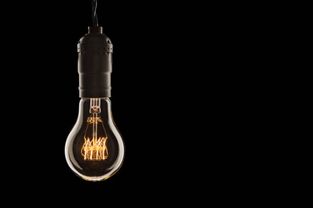 istock Vintage incandescent Edison type bulb on wooden background 1127633313
