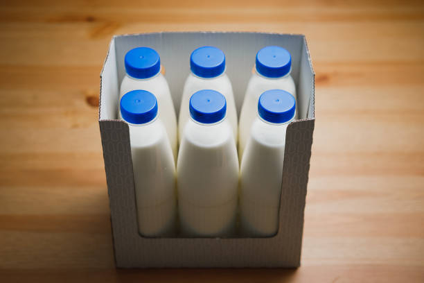 istock milk bottles in cardboard box on wooden table 1127634272