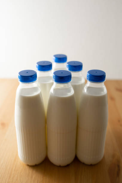 istock milk bottles on wooden table 1127634480