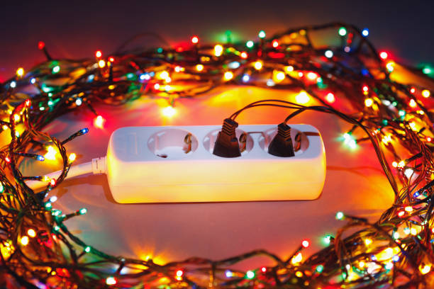 Christmas garland lights circle around electric extension cord