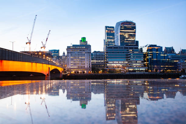 istock london bridge and skyscrapers reflecting at night 1127637075