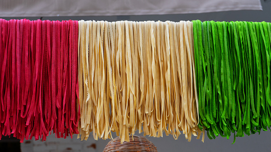 Fresh pasta with the colors of the italian flag (green, red and white)