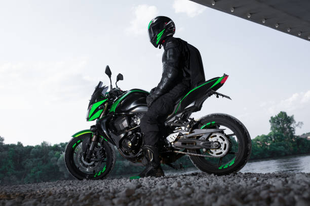 a person dressed in black and green riding