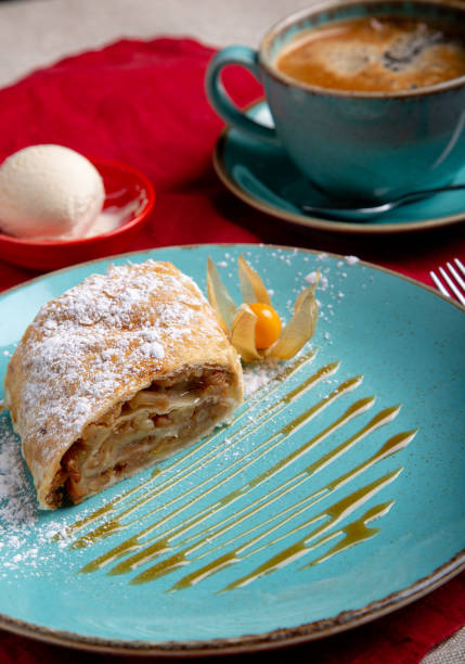 istock Strudel deessrt with ice cream on azure plate and cup of coffe 1127639340