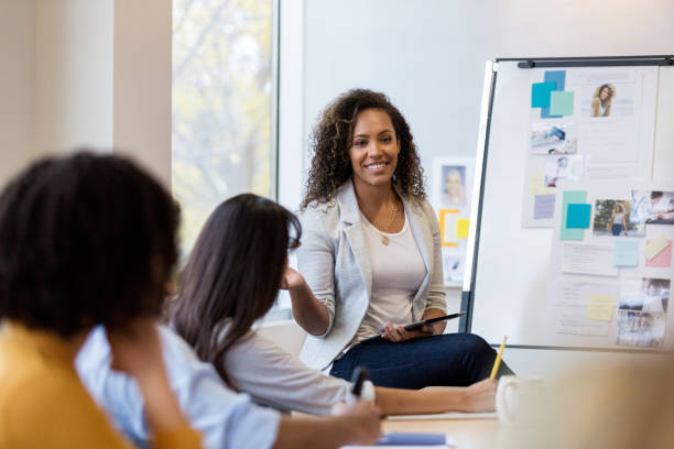 istock Cheerful design manager meets with employees 1127642960