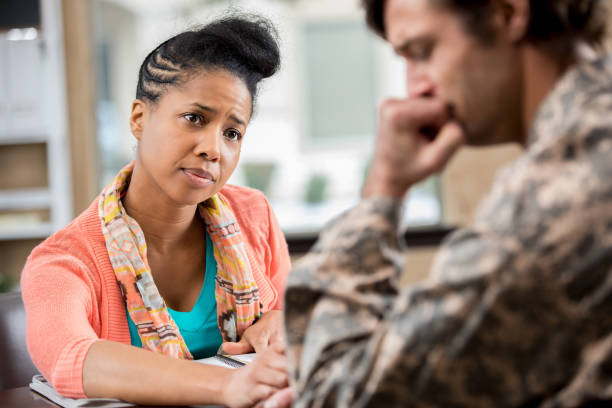istock Female counselor consoles military patient 1127643033