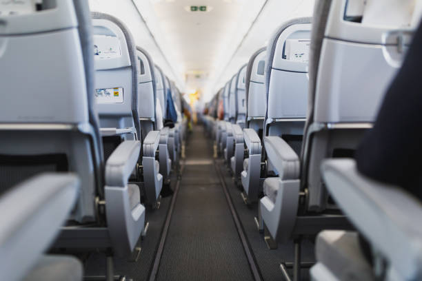 istock airline passenger seats and aisle 1127643259