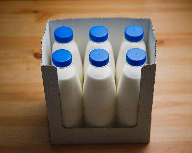 istock milk bottles in cardboard box on wooden table 1127644265
