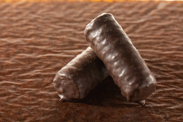 istock Chocolate bars on brown paper background close-up 1127645510