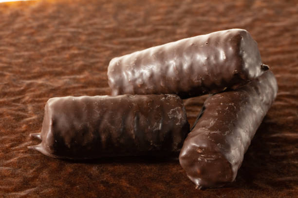 istock Chocolate bars on brown paper background close-up 1127645517