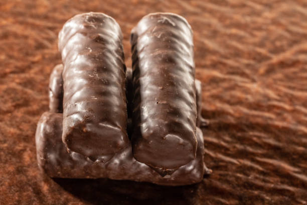 istock Chocolate bars on brown paper background close-up 1127645520