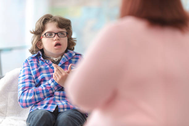 istock Young kid signing with his speech therapist 1127652217