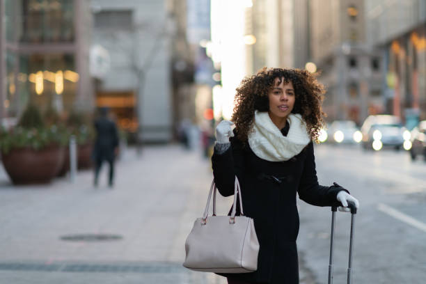 istock Woman on sidewalk waits for her ride 1127652229