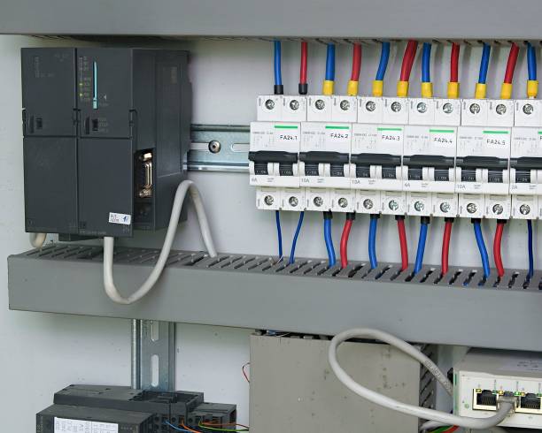 Image shows control cubicle. Schneider electric device and Schneider circuit breakers inside power case. stock photo