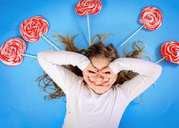 istock Little girl with lollipop 1127658829