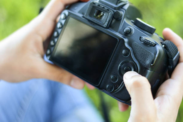 istock Professional woman looking at photo camera 1127660419