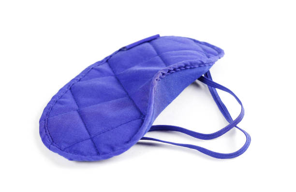 istock Blue mask on eyes. Sleep mask. Close up. Isolated on white background 1127667020