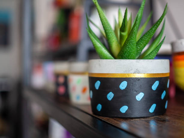 istock Colorful round geometric planters. Painted concrete pots for home decoration 1127668249