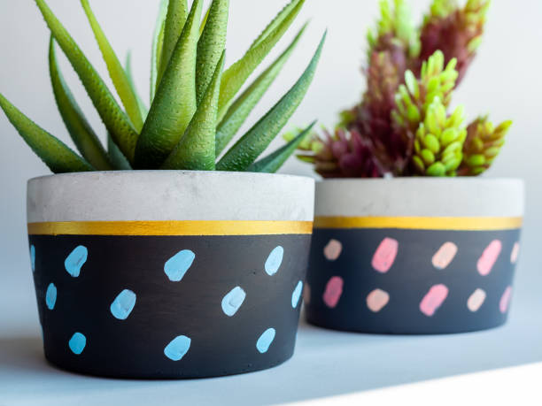 istock Colorful round geometric planters. Painted concrete pots for home decoration 1127668257
