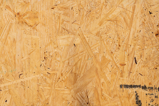 Sub flooring board made of wood chips background.