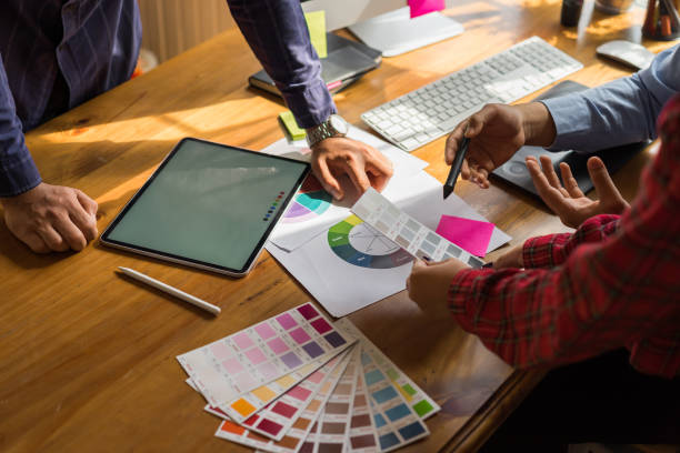 istock Young designers teamwork working with color samples for selection on office desk, Brainstorming Planning Partnership concept. 1127669980
