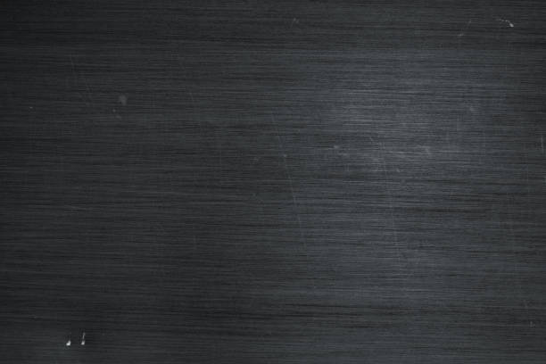 istock Brushed metal texture background. Scratched black stainless steel 1127670075