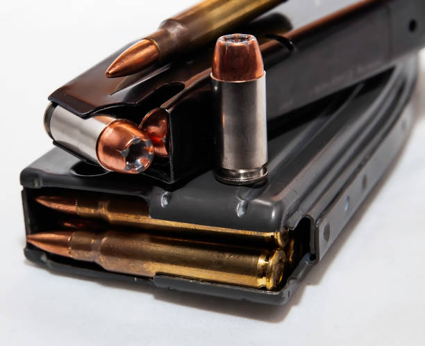 istock Two magazines, one for a pistol and one for a rifle both loaded with bullets with a 40 caliber and 223 caliber shown on top of them 1127673852