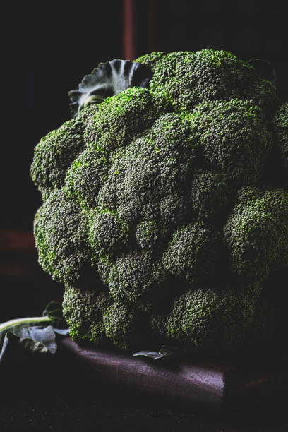 istock Big head of fresh green broccoli on dark rustic table 1127673956