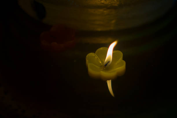 istock candlelight Candles flower floating on a water 1127680596