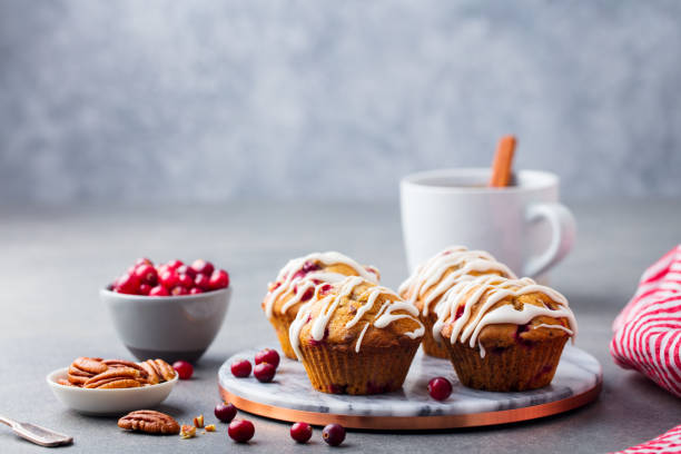 istock Muffins with cranberry and pecan nuts on marble board. Grey stone background. Copy space. 1127685370