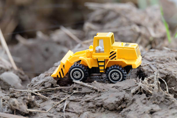 istock Truck model for construction with six gold coins on the cement floor. 1127685579