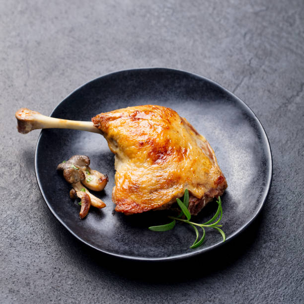 istock Duck legs confit with mushroom sauce. Close up 1127686663