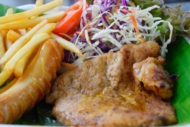 istock Pork steak with hotdog fried and fried fries. 1127690281